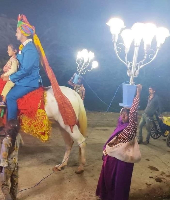 harsh goenka women carrying lamp child