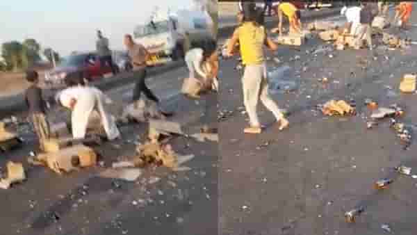 गाडीतून रस्त्यावर पडले दारूचे बॉक्स, तळीरामांची बॉटल्स गोळा करण्यासाठी धावपळ