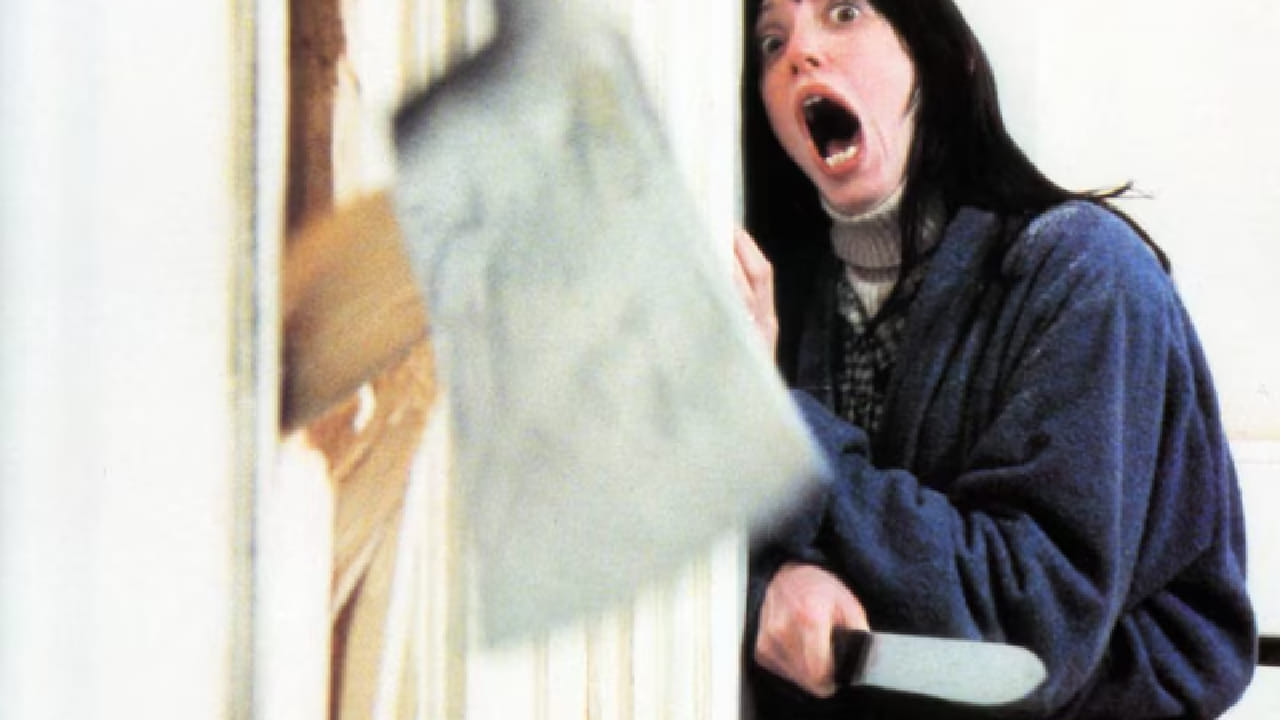 हा चित्रपट प्रसिद्ध दिग्दर्शक स्टॅन्ली कुब्रिक यांनी दिग्दर्शित केला असून त्याची कथा प्रसिद्ध लेखक स्टीफन किंग यांच्या कादंबरीवर आधारित आहे. चित्रपटात जॅक निकोल्सन सह अनेक कलाकारांनी प्रमुख भूमिका साकारल्या आहेत.